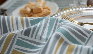 Detail of chenille table runner featuring colorful geometric patterns and woven texture