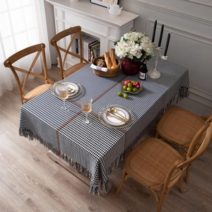 Modern houndstooth plaid tablecloth with grey fringe tassels and geometric grid pattern