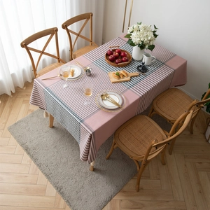 Modern pink and black geometric plaid tablecloth with decorative cream fringe tassels