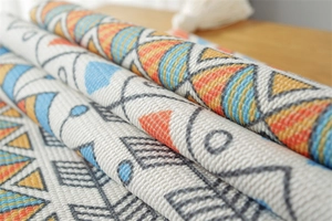 Macro shot of bohemian jacquard dust cover with geometric patterns and white tassels