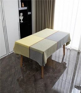 Detail of polyester jacquard tablecloth featuring yellow blocks and houndstooth patterns