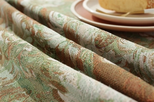 Detailed macro view of retro floral jacquard tablecloth fabric with thick texture