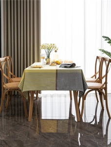Detail of modern woven tablecloth featuring yellow stripes and houndstooth pattern texture