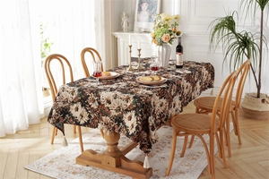 Detail of vintage black floral tablecloth with jacquard oil painting style and tassels