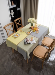 Detailed view of yellow and grey houndstooth jacquard tablecloth with geometric patterns