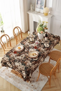 Detail of vintage oil painting style black daisy jacquard tablecloth with white tassels