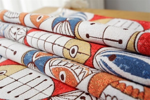 Detailed close-up of chenille fabric with colorful woven jacquard cartoon fish patterns