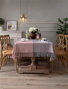 Close-up of pink and grey houndstooth tablecloth with elegant long fringe tassels