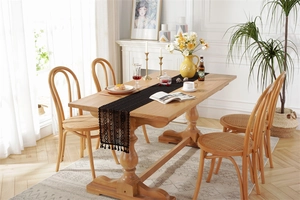 Detail of black crochet lace table runner with hollow design and elegant fringe tassels