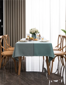 Detailed view of the modern green and houndstooth jacquard patchwork tablecloth on a dining table