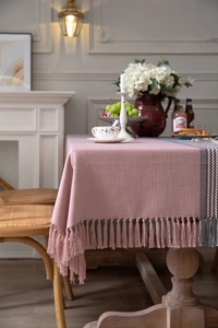 Close-up of pink twill jacquard tablecloth with fringe edges and striped pattern detail