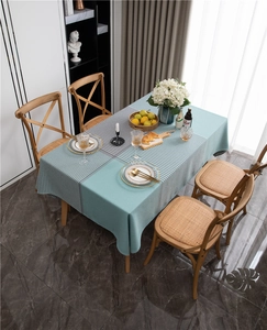 Detail of mint green and black-white checkered patchwork tablecloth with fringe