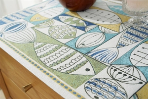 Detailed view of Nordic jacquard fabric showing geometric fish pattern and woven texture