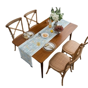 Modern chenille table runner with geometric triangles on a dark wood dining table set