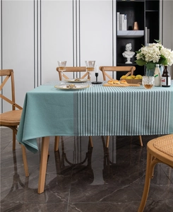 Detailed close-up of teal knit texture and black and white stripes on a modern tablecloth