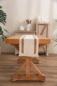 Close-up of woven cotton linen table runner with brown stripes and fringe tassels