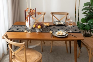 Close-up of jacquard woven geometric patterns and tassel fringe on a retro table runner