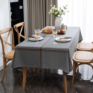 Polyester houndstooth plaid tablecloth with geometric patchwork design on a dining table