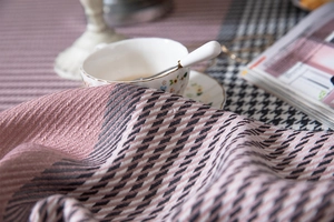 Close-up of pink houndstooth jacquard tablecloth with thick textured woven fabric