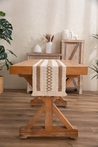 Macro detail of cotton linen table runner with tassel fringe and woven diamond patterns