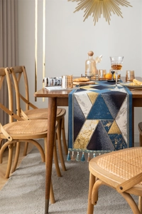 Macro shot of luxury jacquard table runner fabric with geometric patterns and tassels