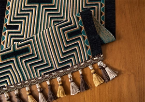 Detailed view of American retro table runner with geometric jacquard patterns and tassels
