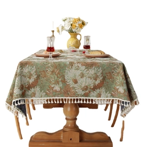 Vintage floral jacquard tablecloth with elegant fringe trim and retro dahlia patterns