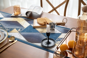 Detail of luxury navy and gold jacquard table runner with geometric marble pattern textures