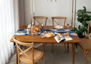 Close-up of geometric pattern jacquard table runner with decorative fringe tassels