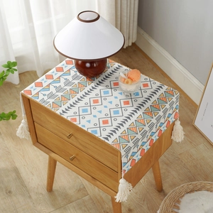Bohemian geometric table runner with blue and orange patterns and white tassels
