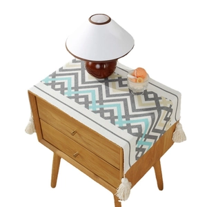 Modern geometric wave pattern dust cover with white fringe tassels for bedside tables