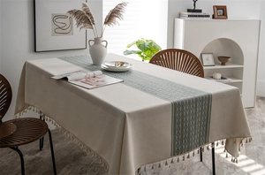Detail of geometric jacquard pattern and delicate fringe tassels on a rectangle tablecloth