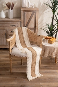 Close-up of bohemian linen table runner with tassels and crochet patchwork detail