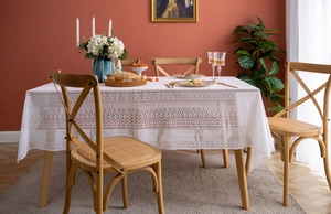 Detail view of French lace tablecloth with intricate hollowed flower patterns and retro design