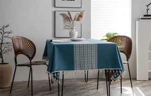Detailed peacock blue table runner with ethnic geometric weaving and beige tassels