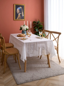 Detail of French lace tablecloth with hollow flower patterns and vintage crochet texture
