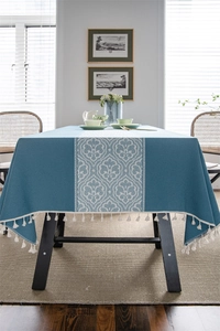 Close-up of ethnic style jacquard table runner with white damascus pattern and tassels