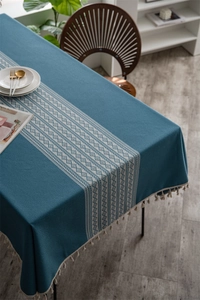 Close-up of geometric jacquard tablecloth with tassels and ethnic rhombus pattern