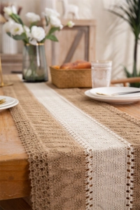 Close-up of linen table runner with woven diamond patterns and tassels in rustic style