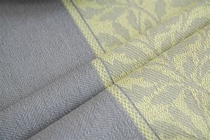 Detail of grey and yellow geometric jacquard fabric with fringe for a stylish tablecloth