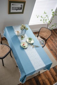 Detailed view of blue bohemian table cloth featuring white jacquard patterns and fringe edges