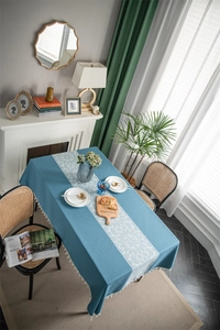 Close-up of blue jacquard tablecloth with mandala pattern and decorative white fringes