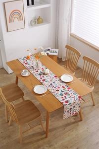 Detailed top view of Easter table runner featuring colorful floral digital prints on cotton fabric