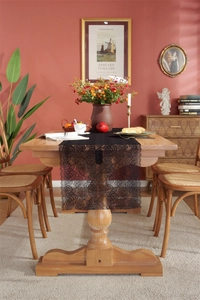 Close-up of black lace table runner with intricate rose patterns on a wooden dining table