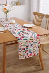 Detail of floral printed table runner showing thick cotton linen texture and hemmed edges