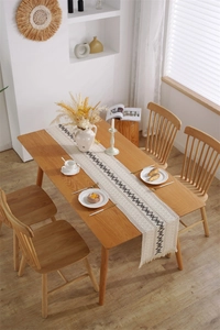 Détail d'un chemin de table bohème en coton et lin avec broderie et glands à franges