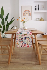 Detail of modern Easter table runner featuring colorful digital floral prints on linen fabric