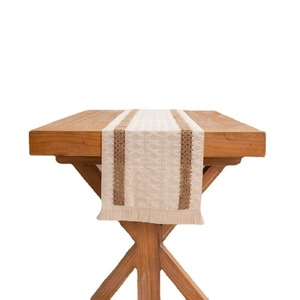 American style linen table runner with brown stripes and tassels on a wooden table