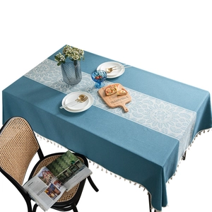 Blue rectangular tablecloth with white bohemian floral pattern and elegant fringe tassels