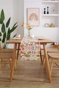 Close-up of Easter table runner with bunny and squirrel prints on a wooden dining table